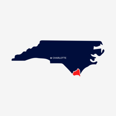 Blue outline of the State of North Carolina with a red outline showing Bunswick county.