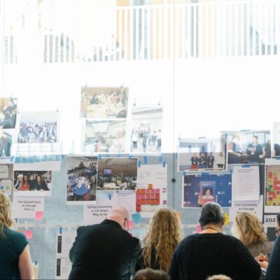 people looking at the wall with notes