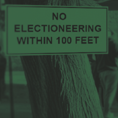 A crowd gathers outside a polling place.